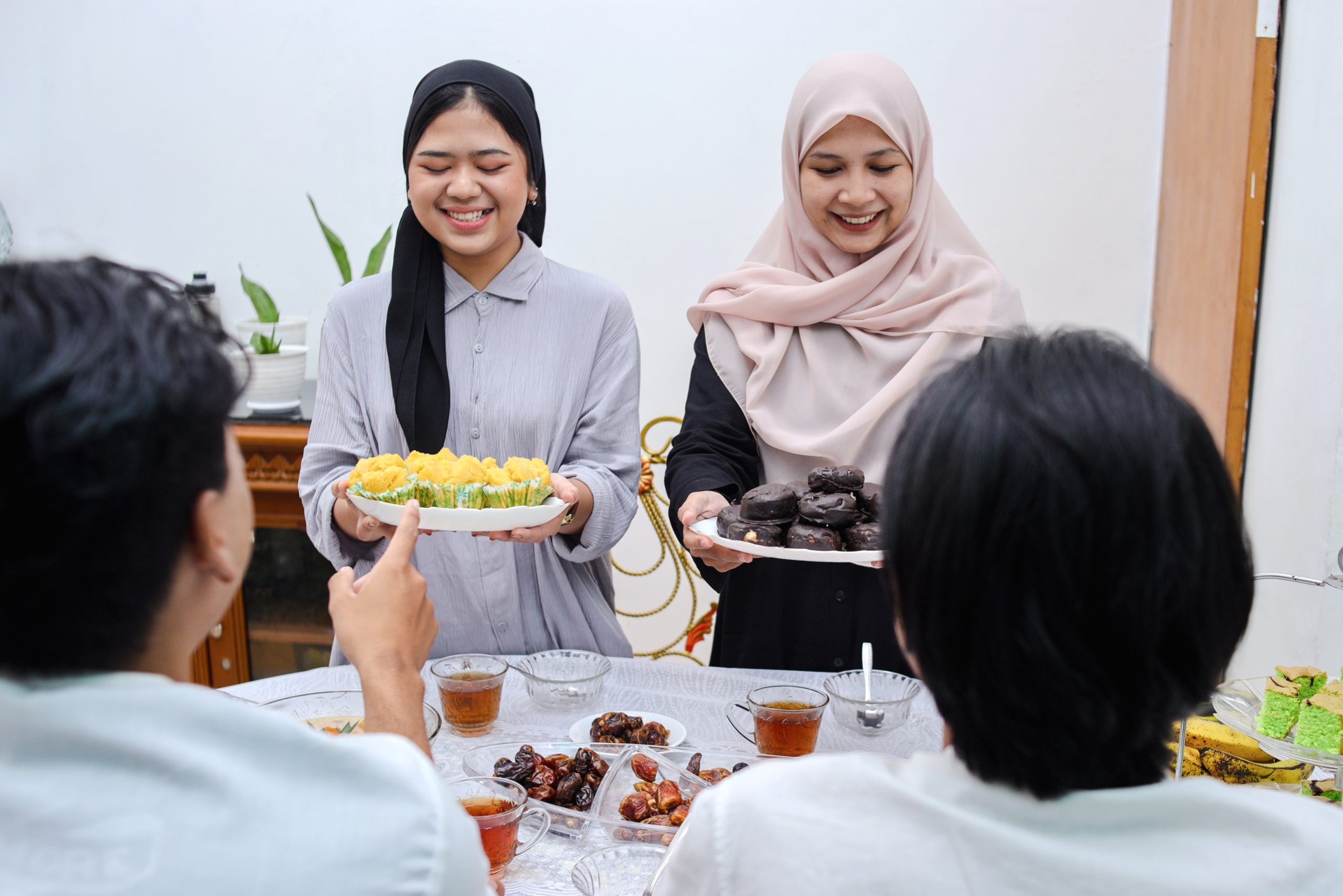 excited-asian-woman-muslim-serving-food-for-break-2025-01-27-10-51-35-utc