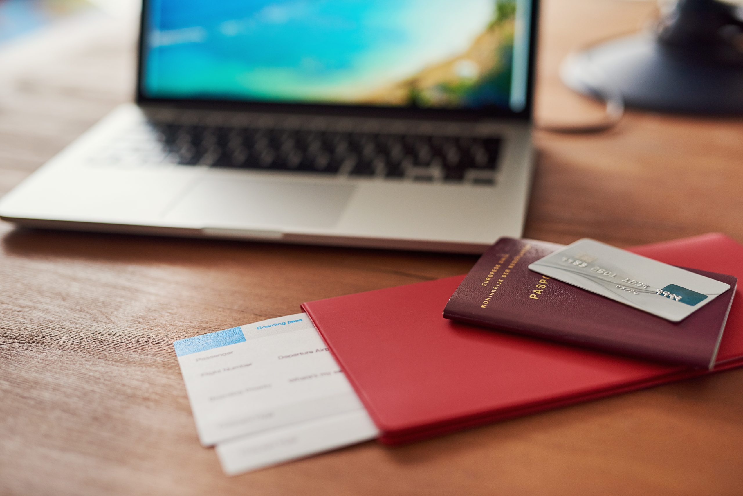 Goodbye business, hello beach. Shot of travel documents and a laptop on a table